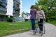 Seniorin mit Rollator vor Pflegeheim